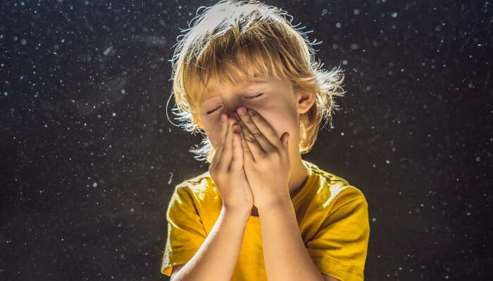 air quality boy sneezing dust in backgound