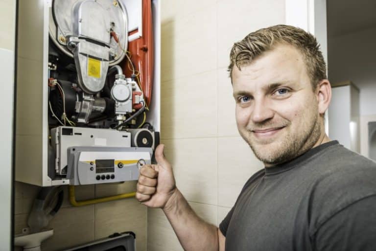 repair man fixing furnace