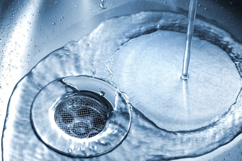 water flowing into bottom of stainless steel sink